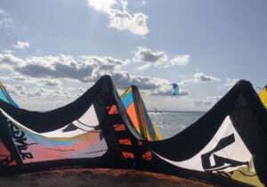 Kiteschirm am Strand von Hel mit Kitesurfer im Meer im Hintergrund